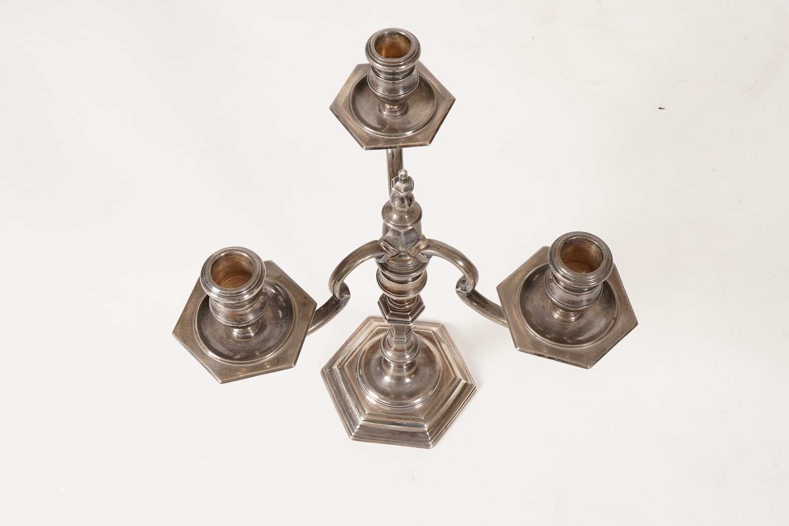 An Elizabeth II silver three branch, three light candelabrum, by William Comyns & Sons Ltd